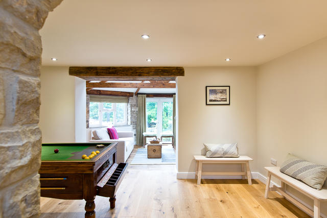 View from the billiards table room through to a light living space