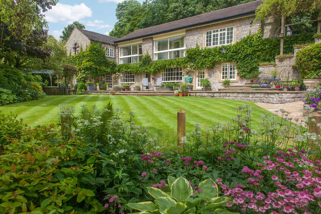 River Cottage has a beautiful garden with a river setting