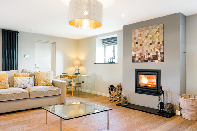 Bright and airy lounge space with fabulous log burner