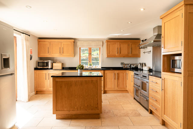 The spacious and bright kitchen is kitted out with everything you need, and pation doors open out to the front patio