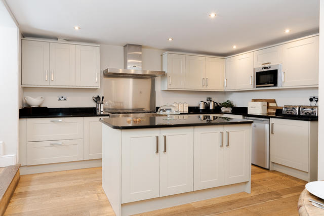 Modern kitchen with electric oven and gas hob