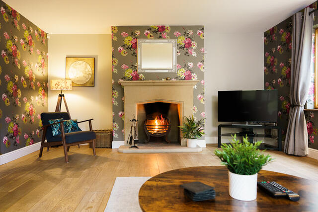 Large lounge area with cosy log burner