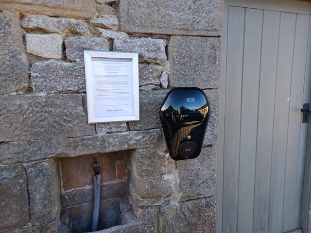 EV charger on the front of the outbuilding opposite The Barn