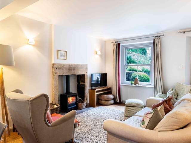 Warm and cosy lounge with ample seating and log burner