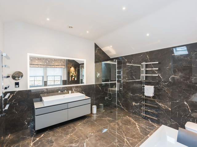 Luxury en suite with shower, bath and marble finish