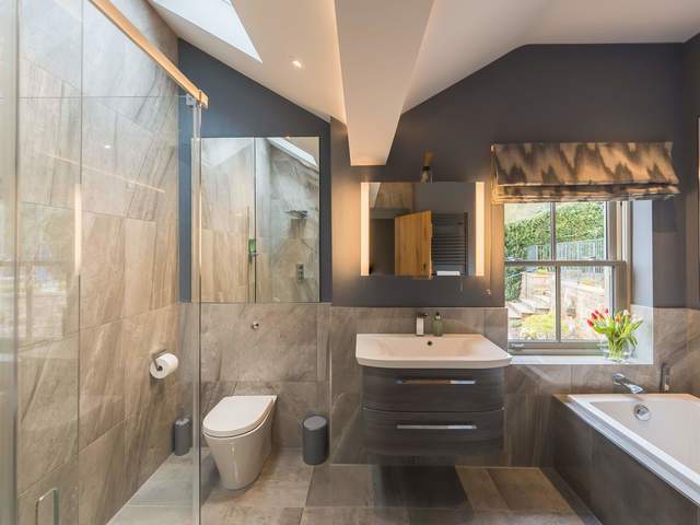 Shared bathroom with bath and separate shower