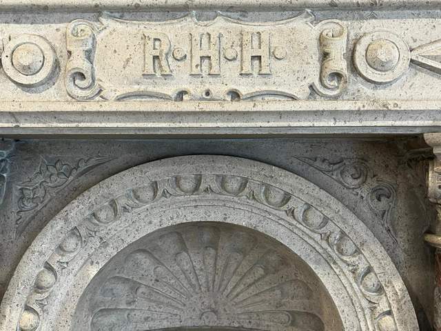 Fireplace bearing the crest of the original owner