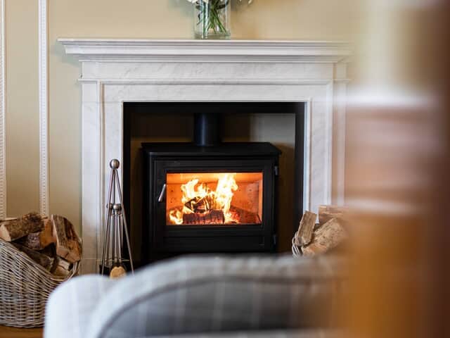 Cosy log burner with a basket of complimentary logs