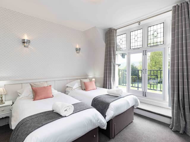 Bedroom 1 with balcony overlooking the garden