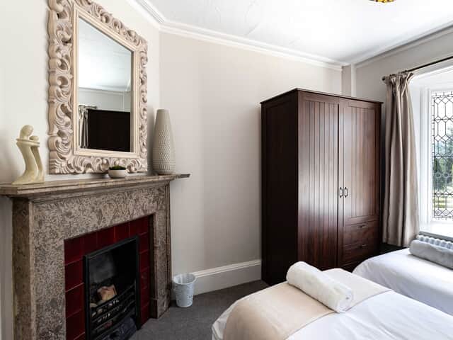 Bedroom 7 ground floor with decorative feature fireplace