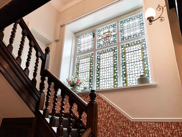 Hand carved banister and impressive stain glass window