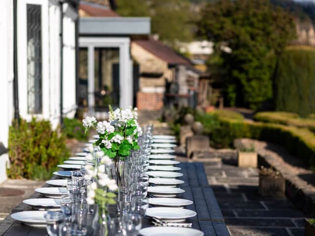 Long dining tables on the patio for 30 guests