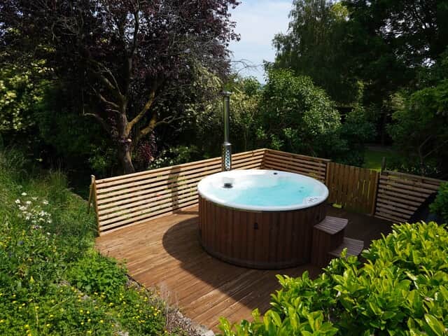 Cliff house features a wood fired hot tub with scenic views