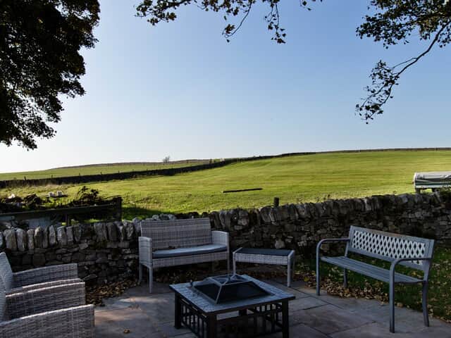 The Farmhouse small patio area with firepit