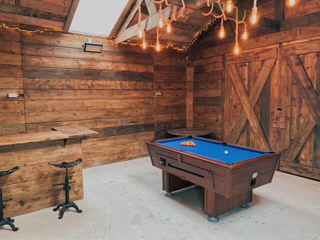 The Farmhouse games room with pool table and small bar area