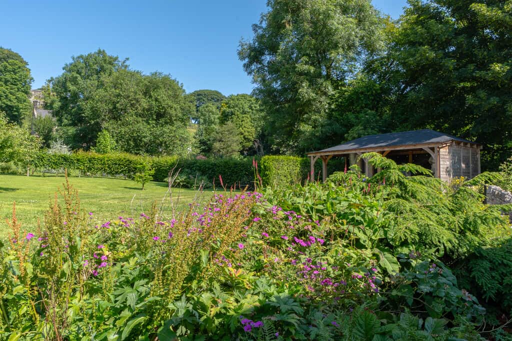 The rear garden and outdoor kitchen at The Stables at Priestcliffe